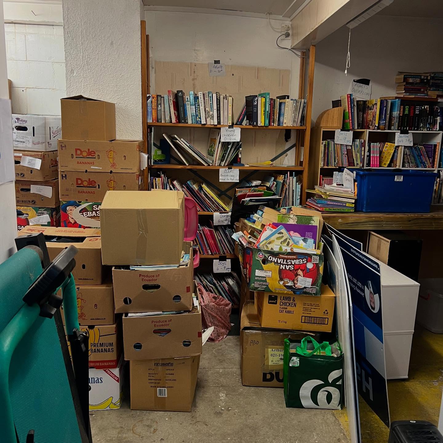 Room filled with donated books for literacy and children’s care packs.