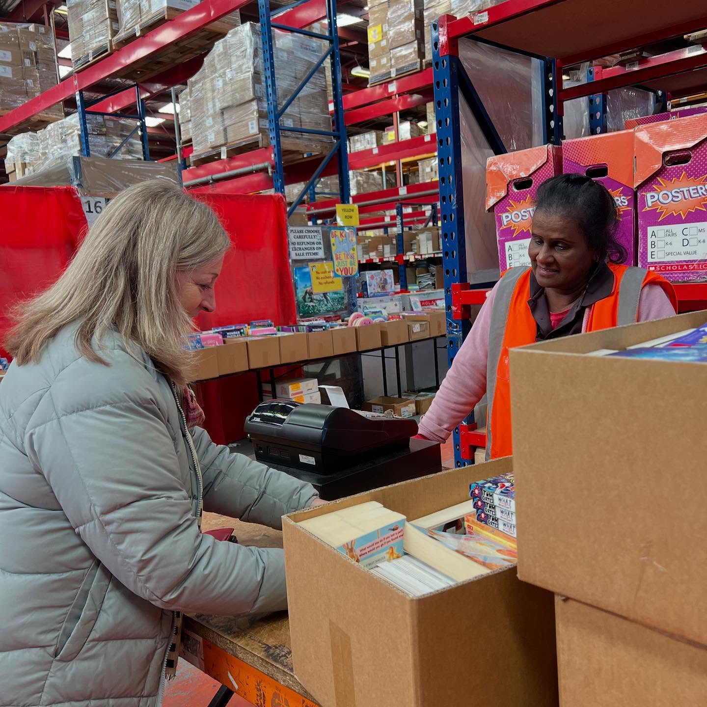 Donation room with toys, food, and essential items for community care packs.