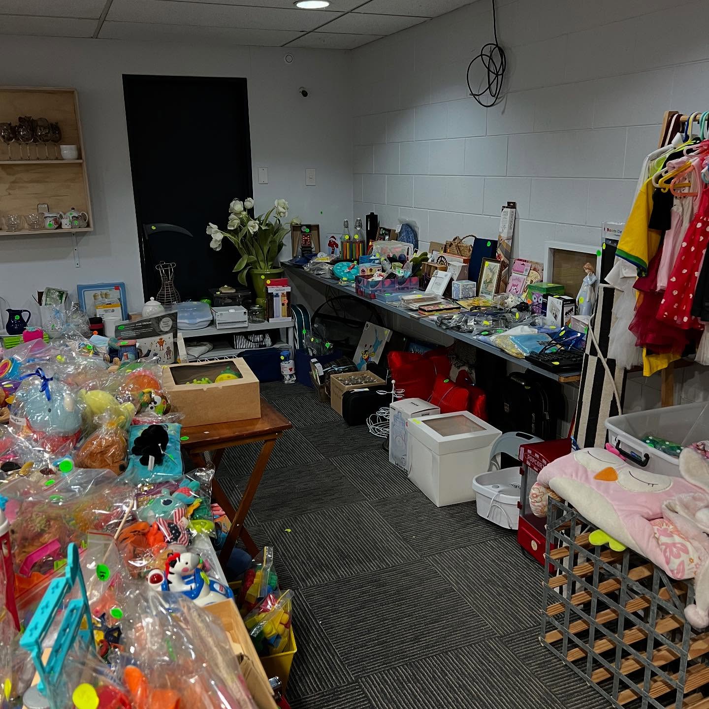 Donation room with toys, food, and essential items for community care packs.